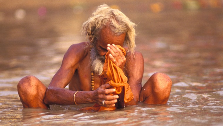 A man washing away sins in the Ganges River
