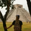 A backpacker visiting Chichén Itzá in Mexico