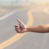 Hitchhiker thumbs up road