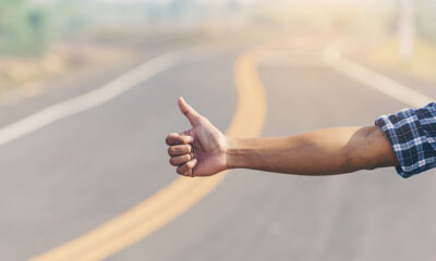 Hitchhiker thumbs up road